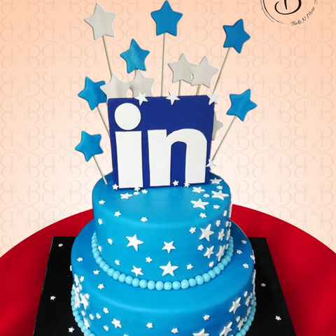 3d Blue cake with star decorations and linkedin topper on a red and beige background